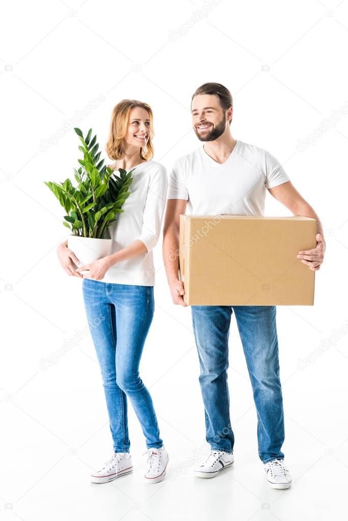 Couple holding box and plant