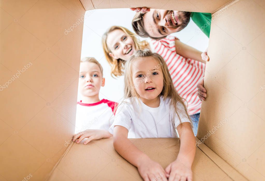 Family peeking from cardboard box