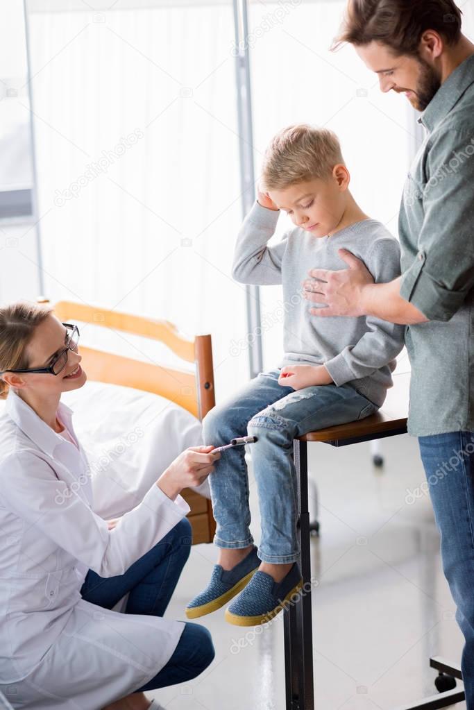 Doctor inspecting little boy