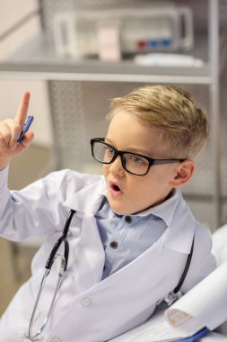 Little boy pretending to be doctor clipart