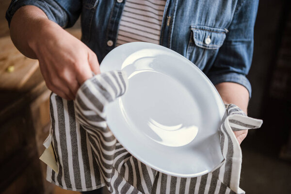 Woman wiping plate
