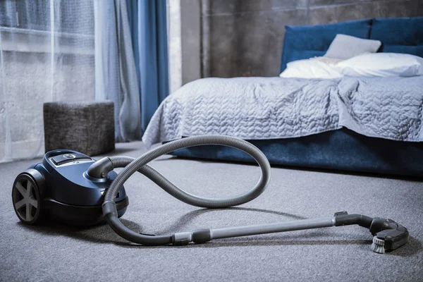 Vacuum cleaner in bedroom — Stock Photo, Image