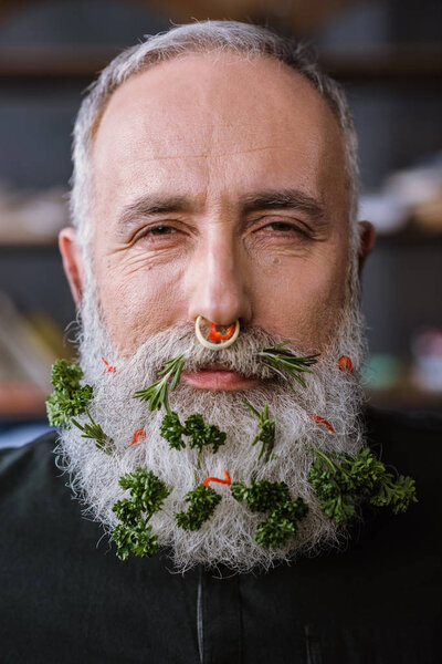 Senior man with greens in beard