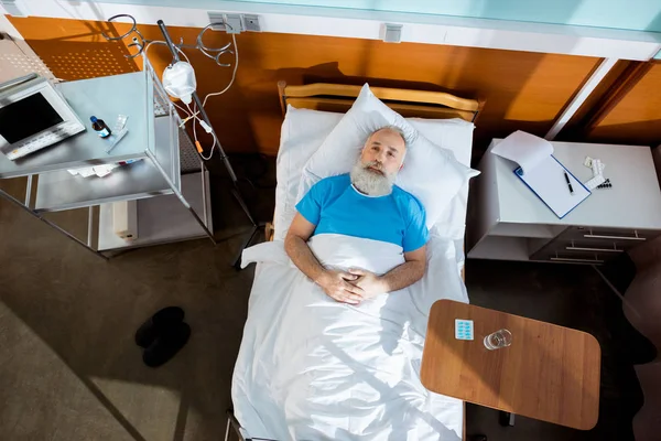 Homme âgé dans un lit d'hôpital — Photo