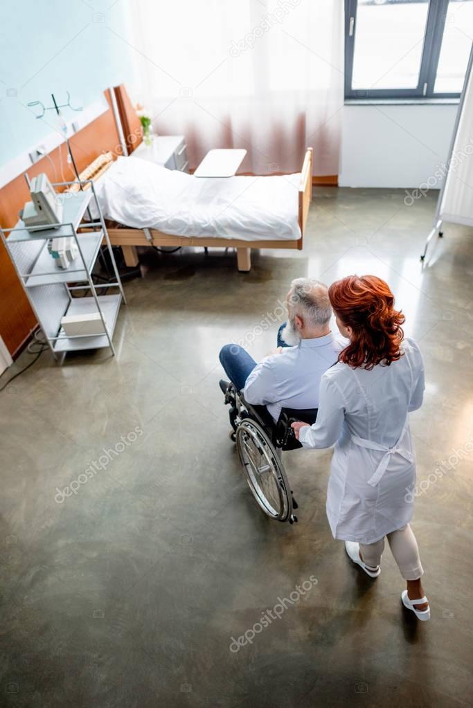 Doctor and patient in wheelchair 