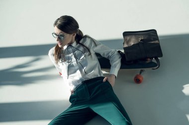 stylish hipster woman with skateboard