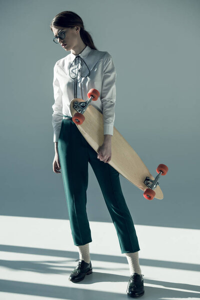 hipster woman holding skateboard