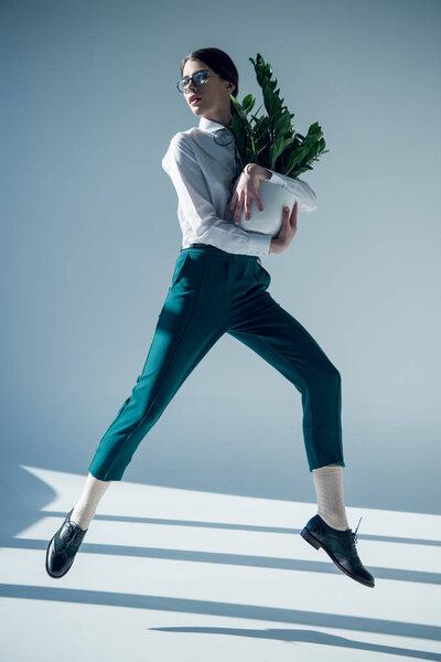 hipster woman in white shirt with plant