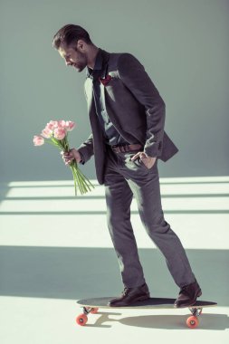 fashionable man holding tulips
