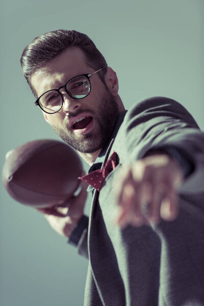 Stylish man with rugby ball