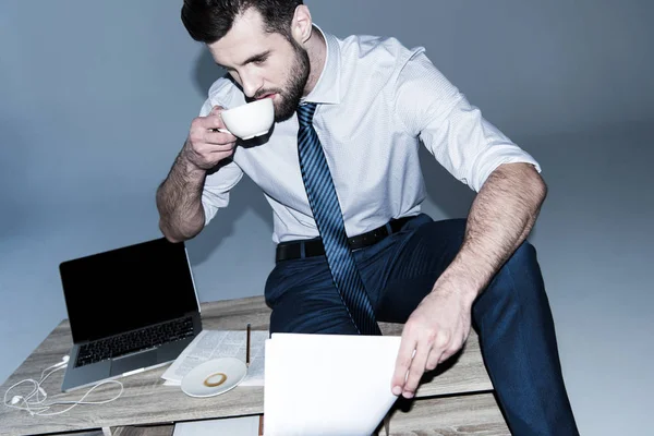 Businessman sitting on table — Stock Photo, Image