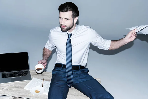 Businessman sitting on table — Stock Photo, Image