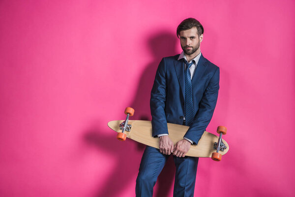man in suit with skateboard