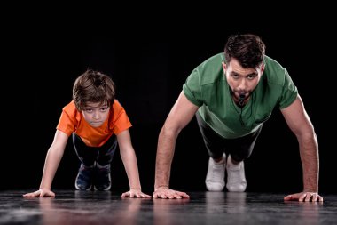 man and boy training together clipart