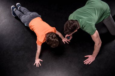 man and boy training together clipart