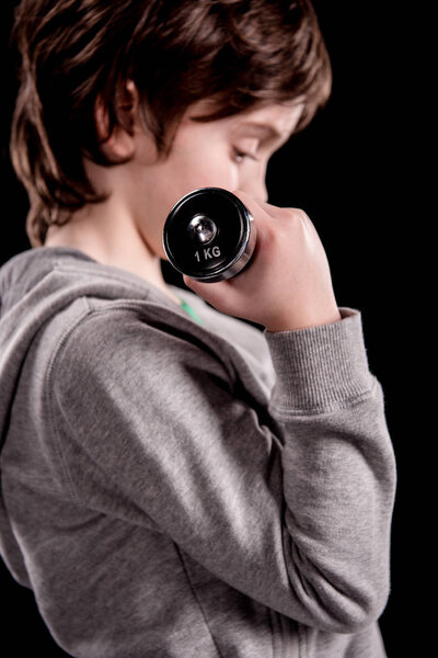 Boy exercising with dumbbell