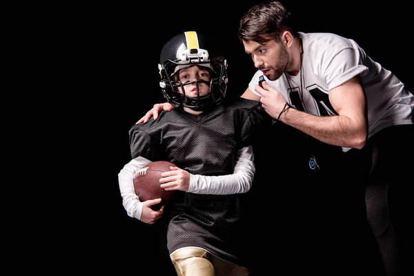 Boy playing football with trainer — Stock Photo, Image