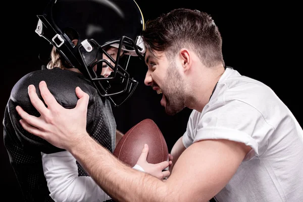 Boy playing football with trainer — Stock Photo, Image