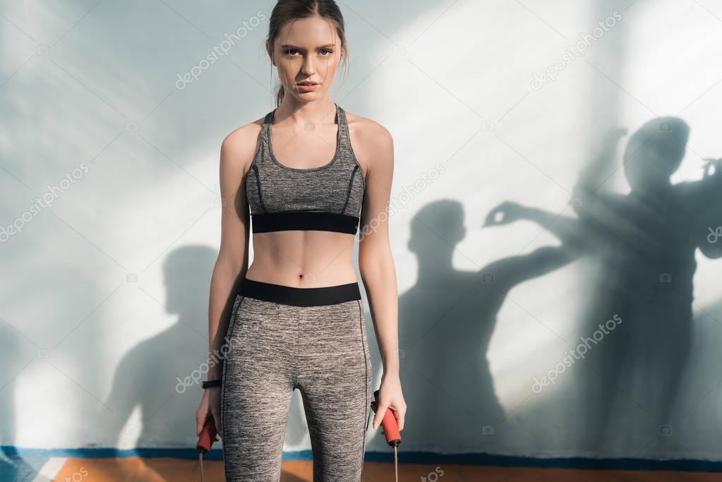 sporty woman with skipping rope