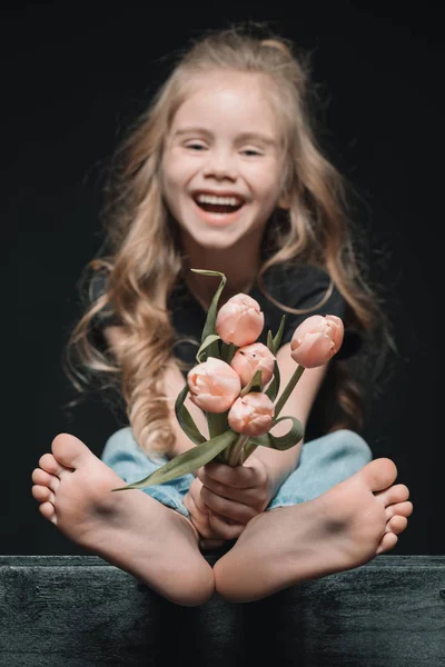 Little girl with tulips — Stock Photo, Image