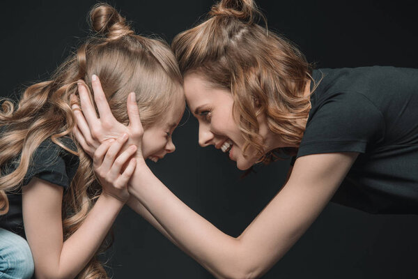 daughter and mother smiling