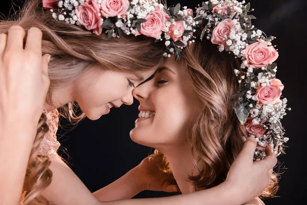 Mother and daughter in wreaths — Stock Photo, Image