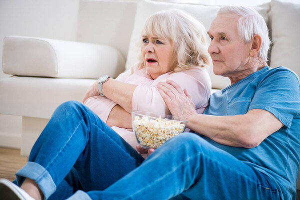 senior couple watching tv
