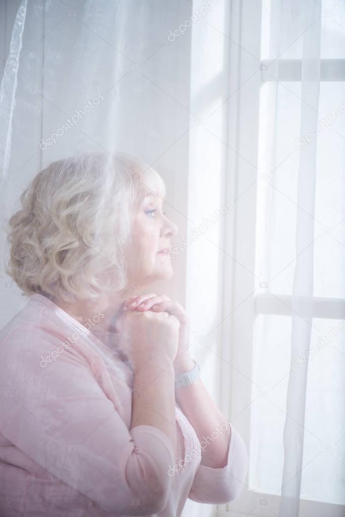 Senior woman at window