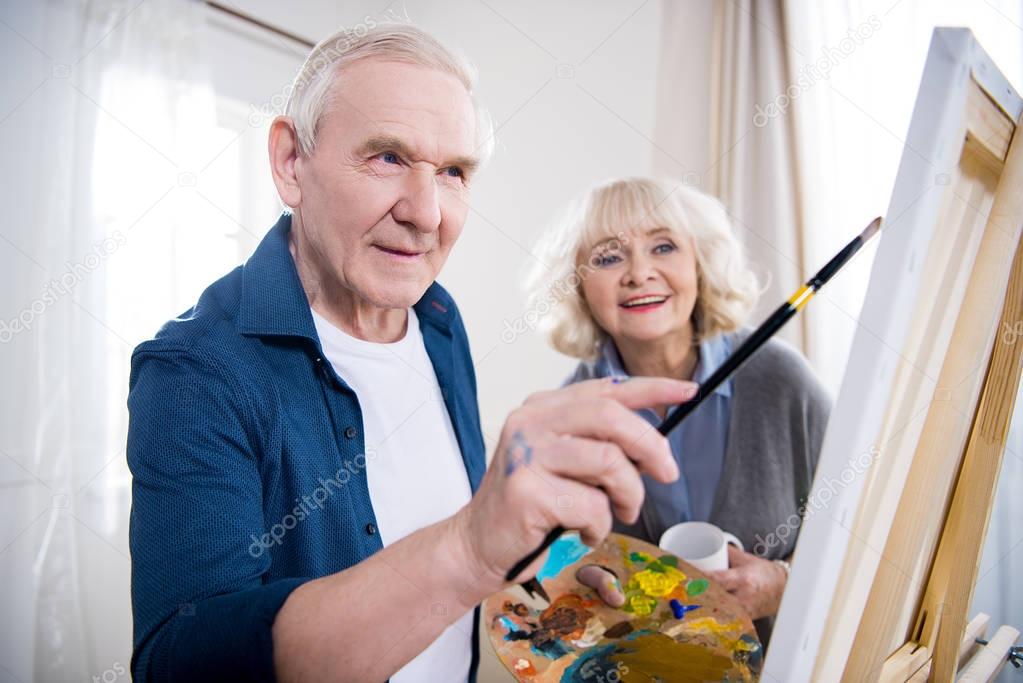 Senior couple painting