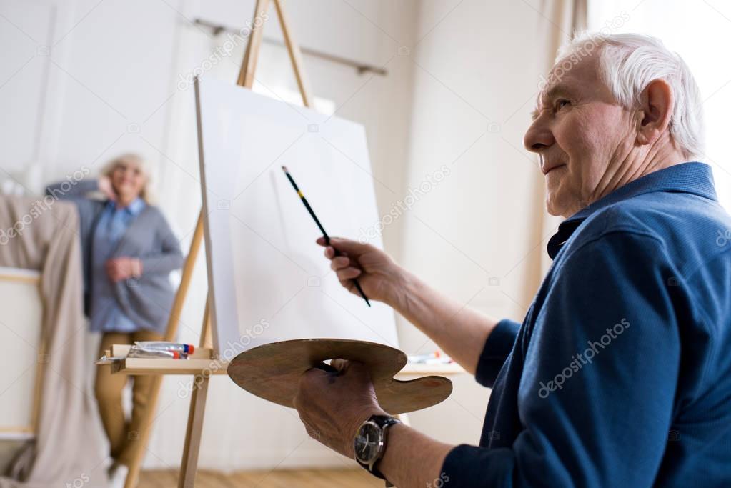 man drawing portrait of woman