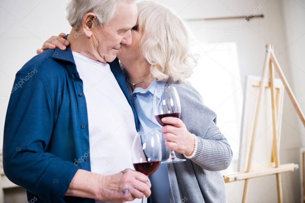 senior couple with glasses of wine