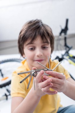 boy with bicycle multi tool  clipart