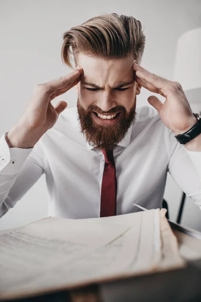 Stressed businessman with documents — Stock Photo, Image