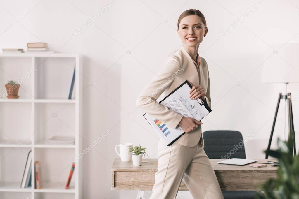 Young businesswoman with clipboard 