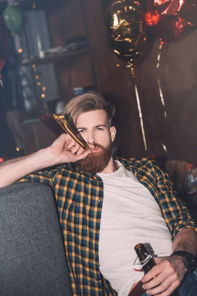 Young man with party blower — Stock Photo, Image