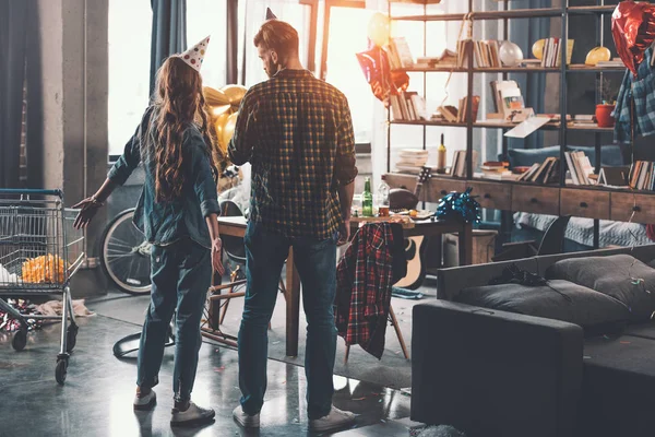 Couple in messy room after party — Stock Photo, Image