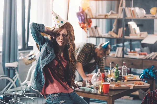 Confused woman in birthday hat — Stock Photo, Image