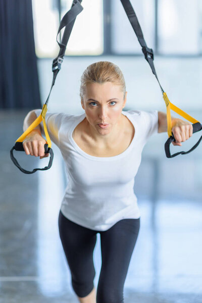 sportswoman training with resistance band 