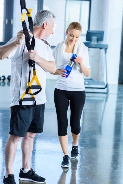 Sportswoman and sportsman with resistance band — Stock Photo, Image