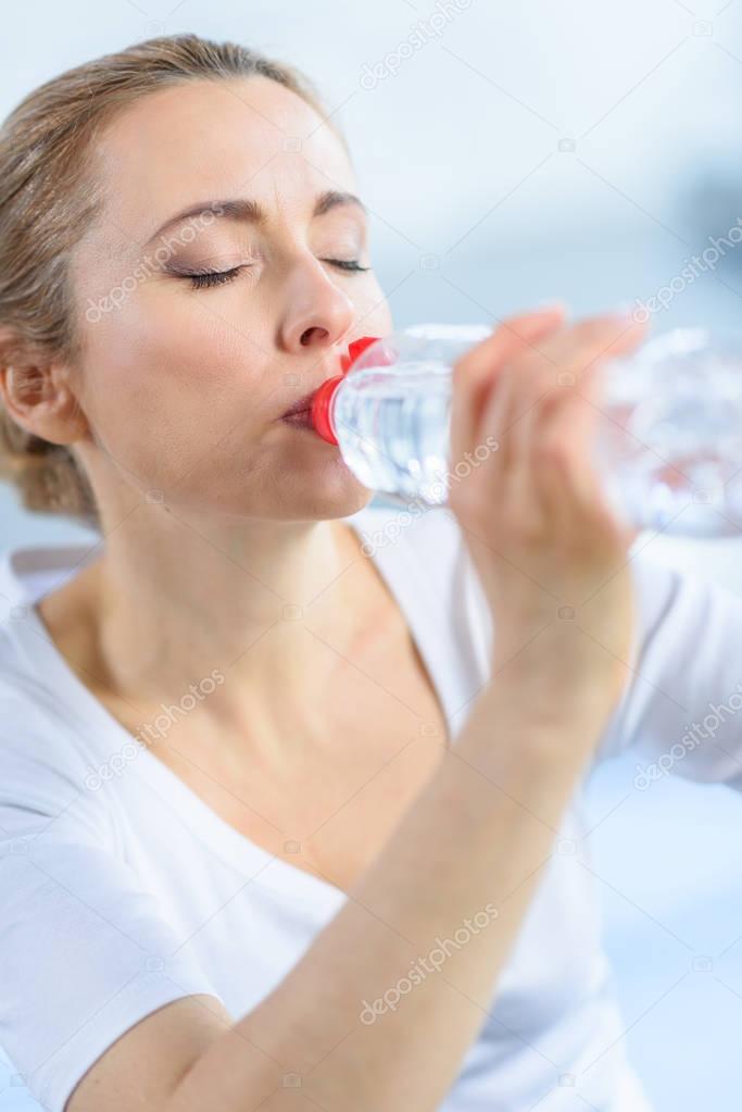 sportswoman drinking water