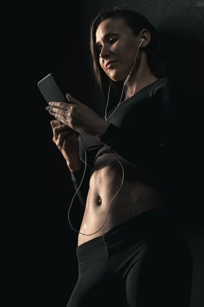 Mulher desportiva usando smartphone — Fotografia de Stock