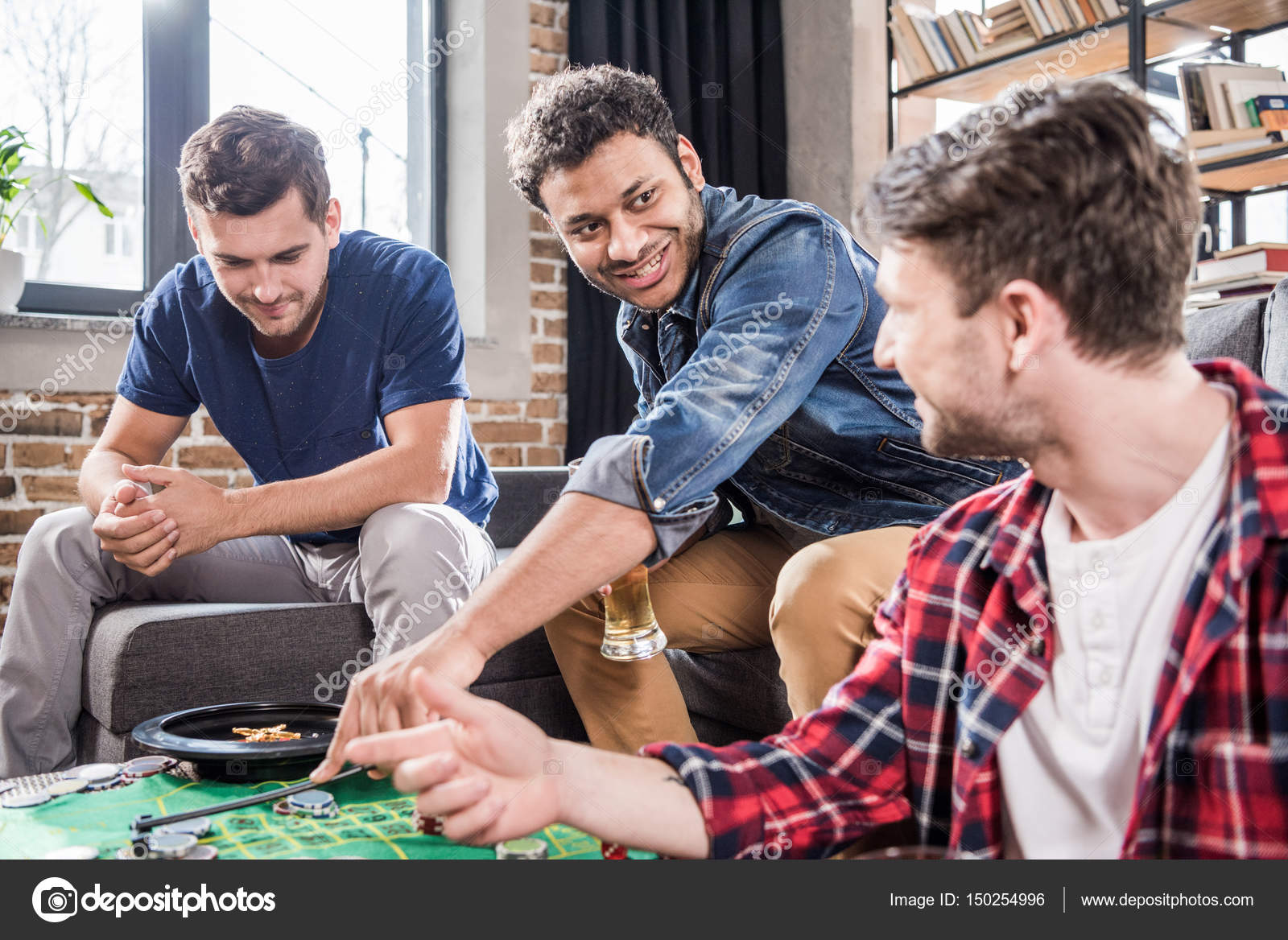 Men playing roulette game — Stock Photo © ArturVerkhovetskiy 150254996