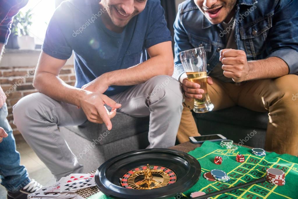 Young men playing roulette game. young people having fun concept