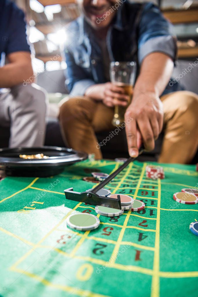 Young men playing roulette game. young people having fun concept
