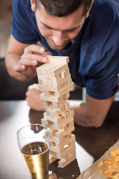 man playing jenga game 