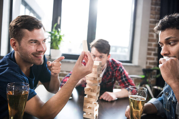 men playing jenga game