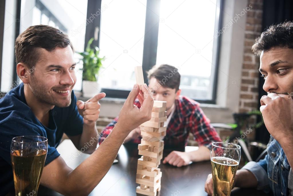 men playing jenga game