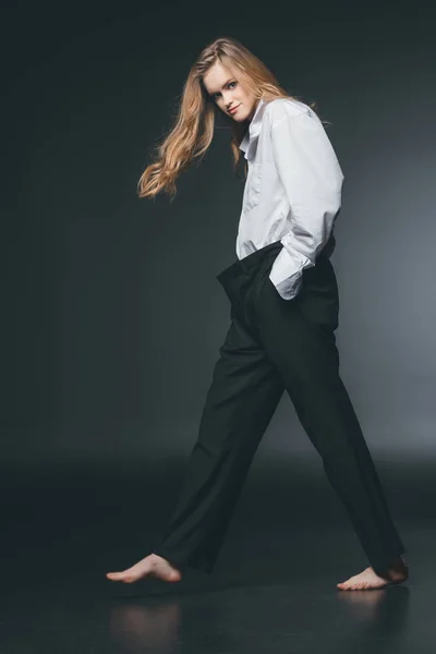 Mujer de pie y posando sobre negro — Foto de Stock