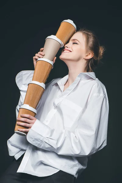 Woman holding pile of disposable coffee cups — Stock Photo, Image