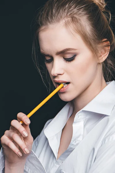Woman with pencil in mouth — Stock Photo, Image